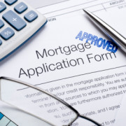 Approved Mortgage application form with a calculator and pen